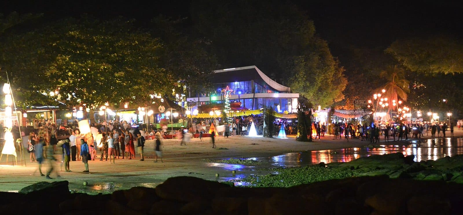 Lights and crowds on a Koh Samet beach at night