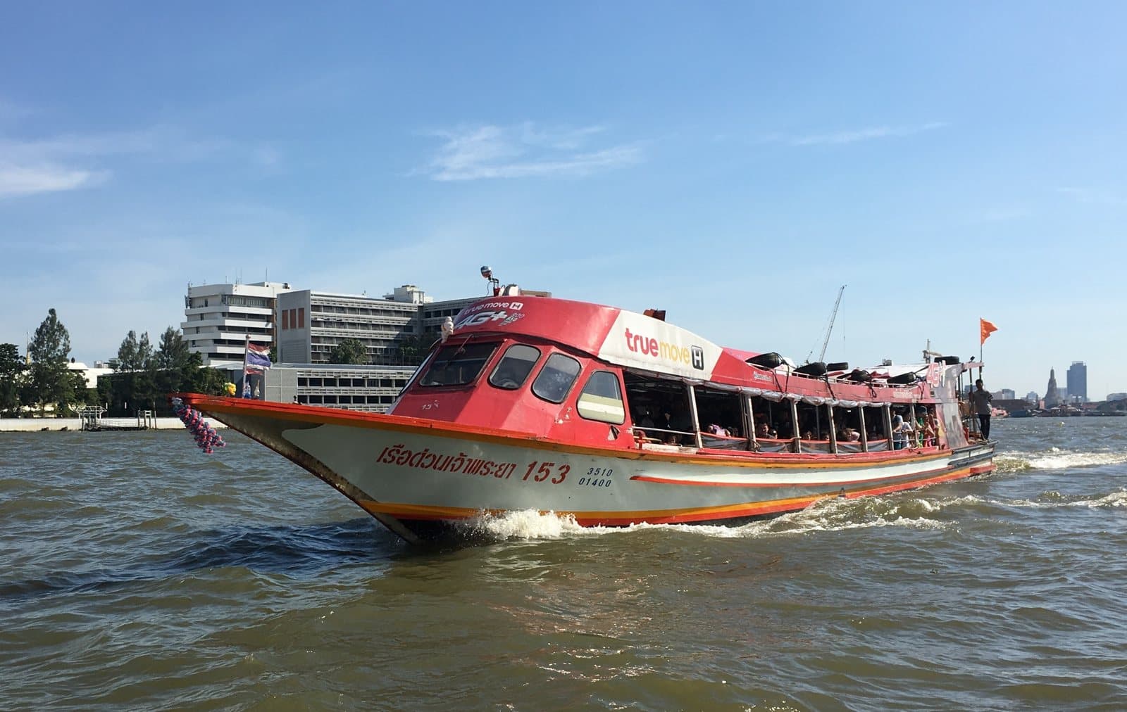 An orange-flag Chao Phraya Express boat
