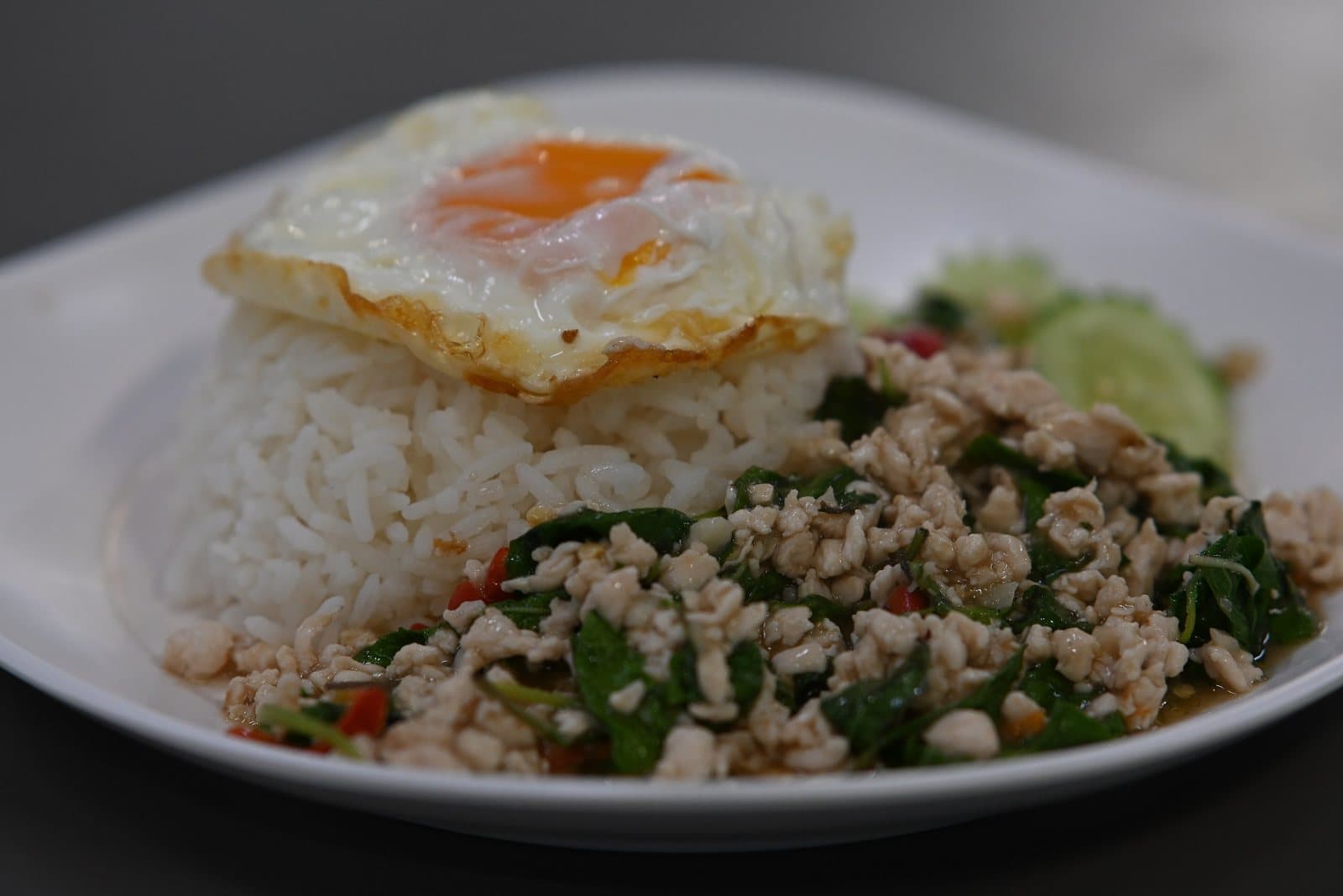 Pad kra pao with a fried egg on rice