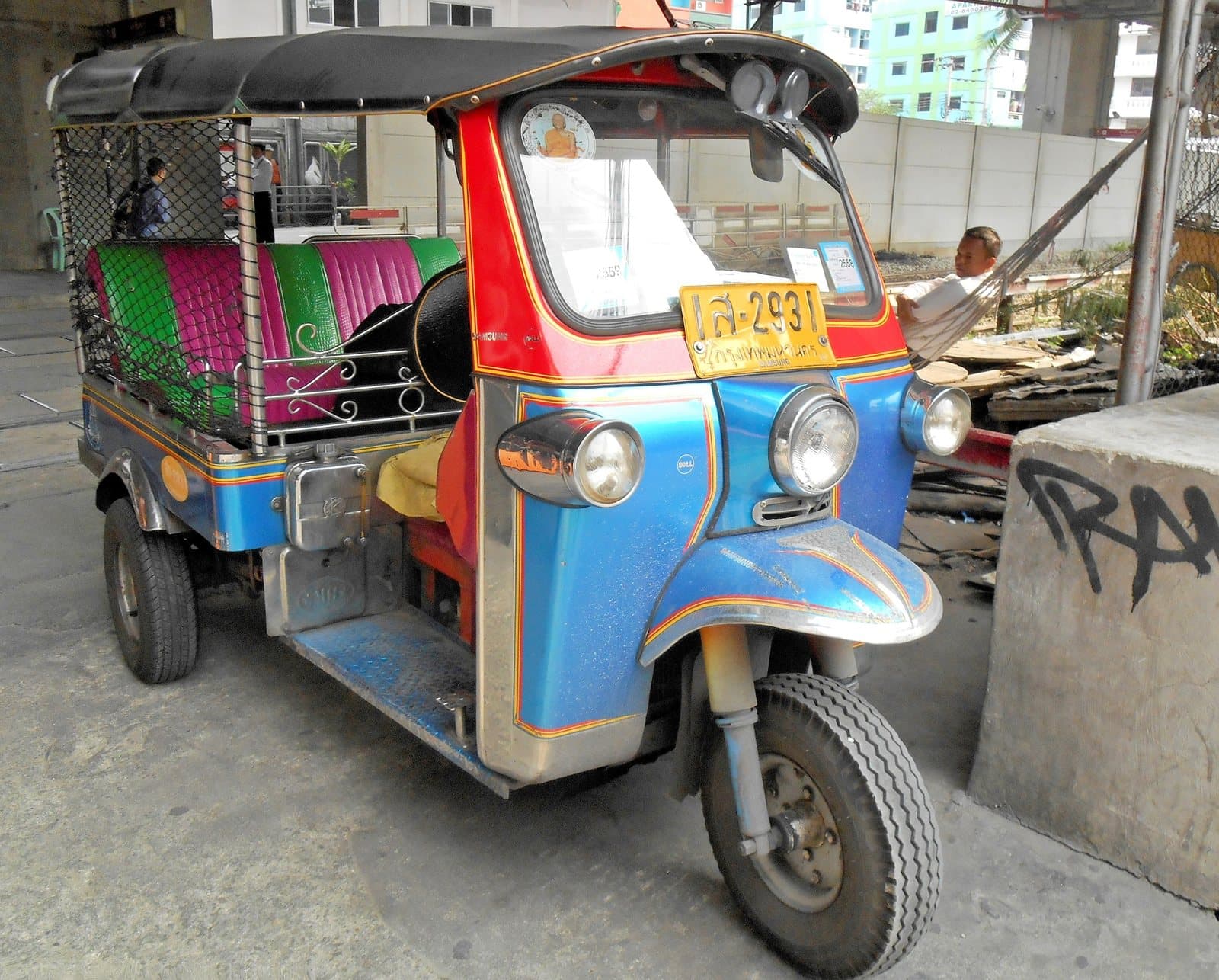 A tuk-tuk parked on a Bangkok street